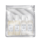 A clear zip pouch containing four small white bottles of Sacha Juan haircare products, photographed on a clean white background.