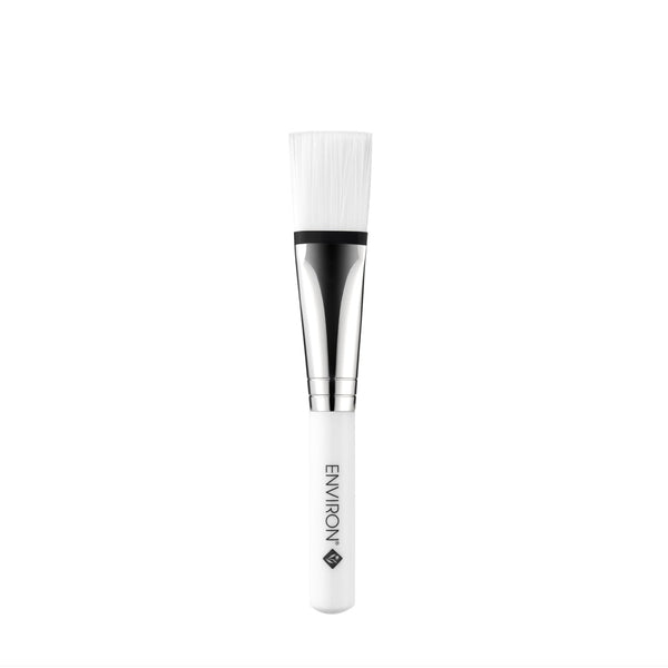 White makeup brush with black bristle tip on a white background