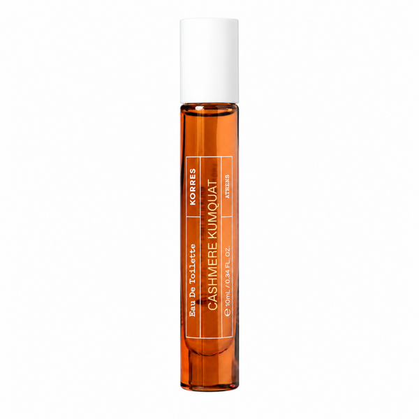 A clear glass rollerball perfume bottle filled with amber liquid, featuring a white cap and white text that reads 'CASHMERE KUMQUAT' and 'KORRES'.