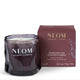 A NEOM Wellbeing London Sparkling Joy scented candle in a dark purple glass jar, shown next to its matching dark burgundy box on a clean white background.