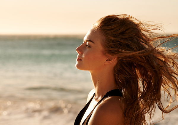 Woman on beach with hair blowing in the wind