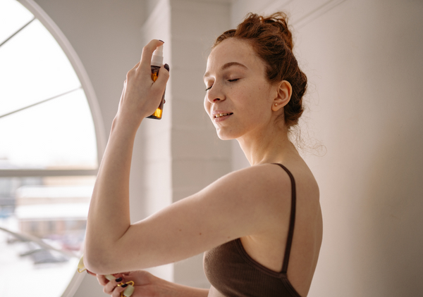 woman applying face mist