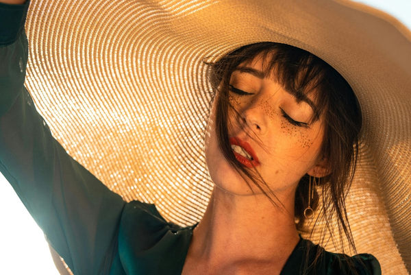 woman wearing sun hat in sunshine