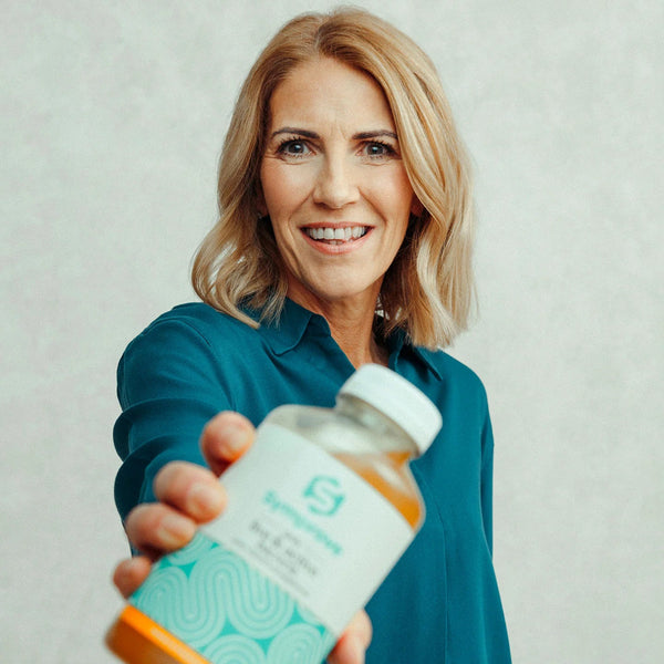 Symprove probiotic bottle and glass showing water-based formula