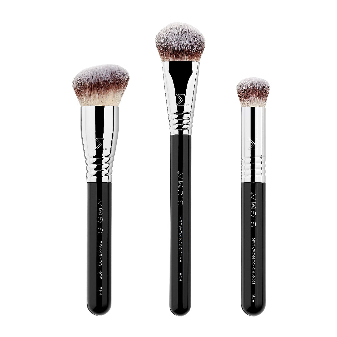 Three Sigma makeup brushes with black handles and silver ferrules on a white background