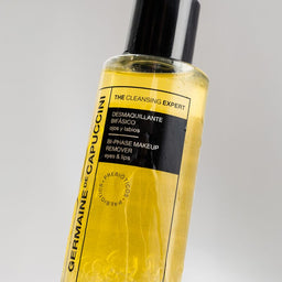Bottle of Germaine de Capuccini skincare product on a gray background