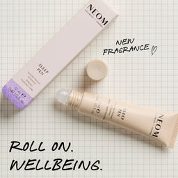 Neom Sleep Pen on a checkered background with text about new fragrance and roll-on wellbeing.