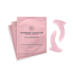 Two pink sachets of Germaine de Capuccini Timexpert Wrink-Less alongside two pink textured silicone eye patch stickers on a white background.