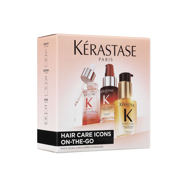 Kérastase Paris Hair Care Icons On-the-Go set in a light pink box, featuring three travel-sized hair care bottles: a pink serum bottle, a dark brown oil bottle, and a gold conditioner bottle.