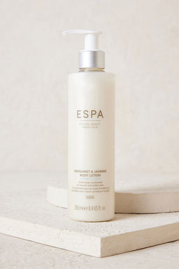 ESPA Bergamot & Jasmine Body Lotion bottle on a slate slab