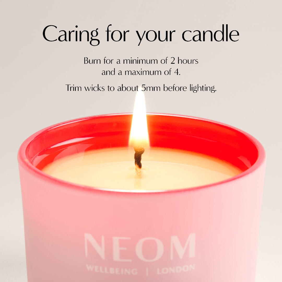 Neom candle with instructions on care and usage.
