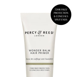A white squeeze tube of Percy & Reed London Wonder Balm Hair Primer with black text, shown on a white background with a black circular badge in the top right.