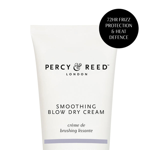 A white squeeze tube of Percy & Reed London Smoothing Blow Dry Cream with black text, featuring a black circular badge on the top right that reads '72HR FRIZZ PROTECTION & HEAT DEFENCE'.