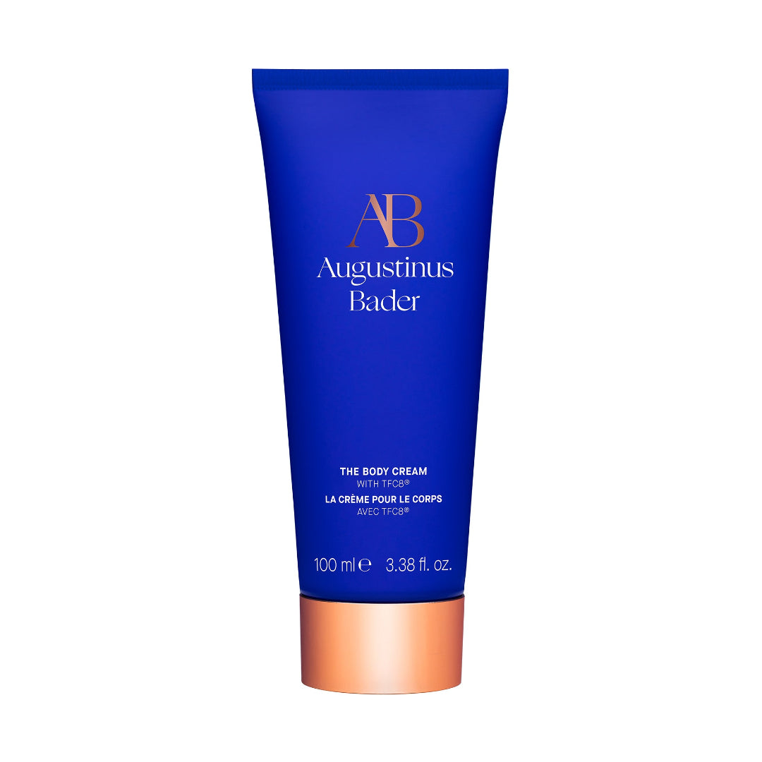 Blue tube of Augustinus Bader body cream on a white background