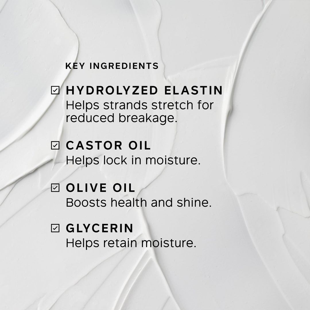 A close-up of a white cosmetic cream with visible texture and printed text listing key ingredients: hydrolyzed elastin, castor oil, olive oil, and glycerin.