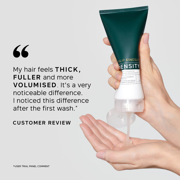 Hand holding a tube of hair care product with a customer review quote on a light gray background