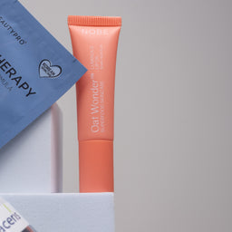 Beauty product with a blue packaging on a gray background