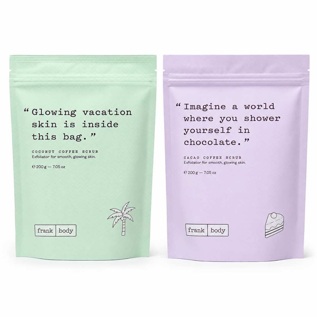Two stand-up pouches of Frank Body exfoliating scrubs side by side on a white background. The left pouch is a light mint green for Coconut Coffee Scrub, and the right pouch is a light lavender purple for Cacao Coffee Rinds.
