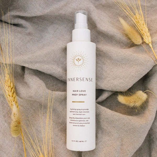 Innersense Hair Love Prep Spray on a towel surrounded by wheat strands