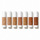 Six white cosmetic tubes arranged in a row on a white background, each showing a different shade of tan and brown seed beads in the clear center window.