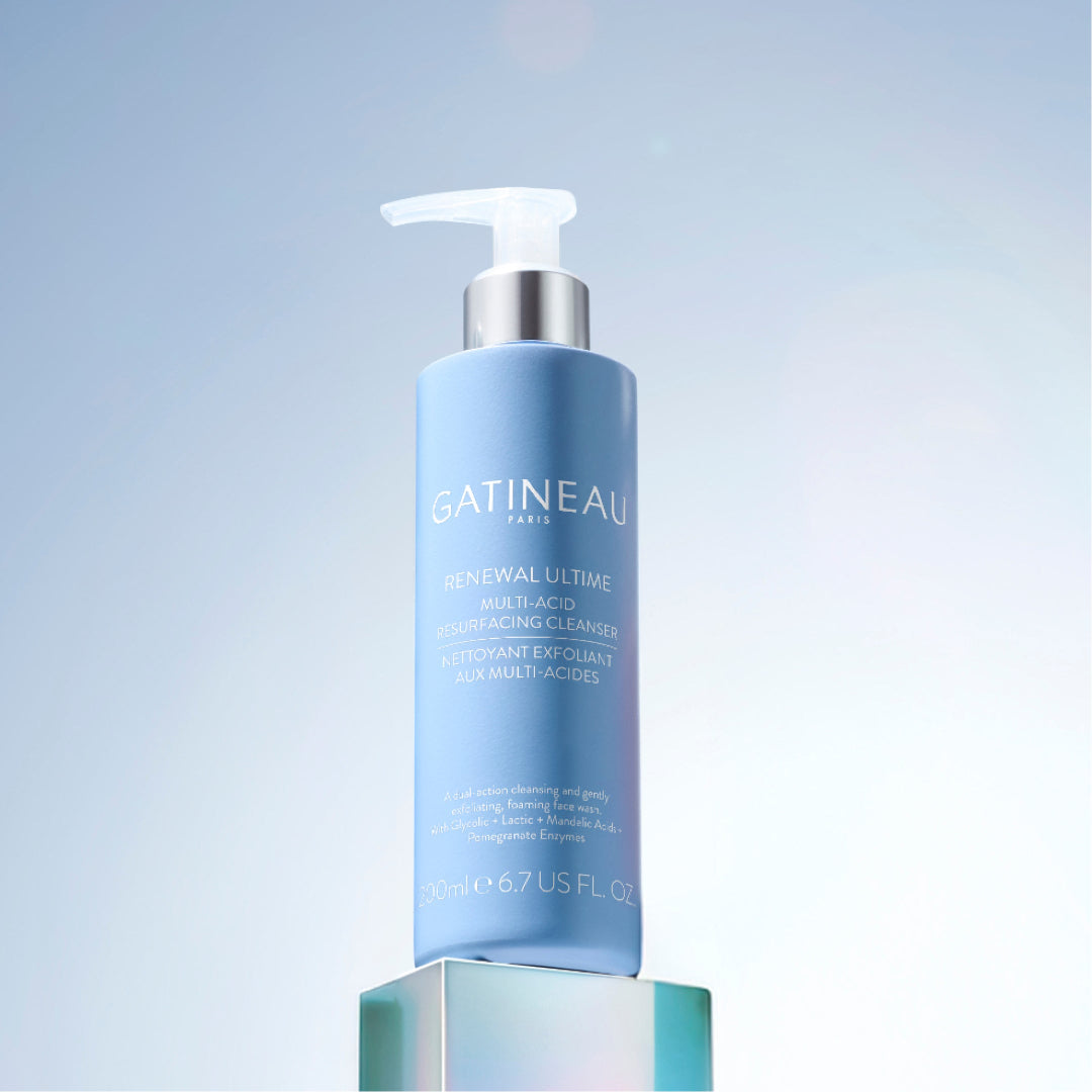 Blue skincare bottle with white pump on a gradient blue background