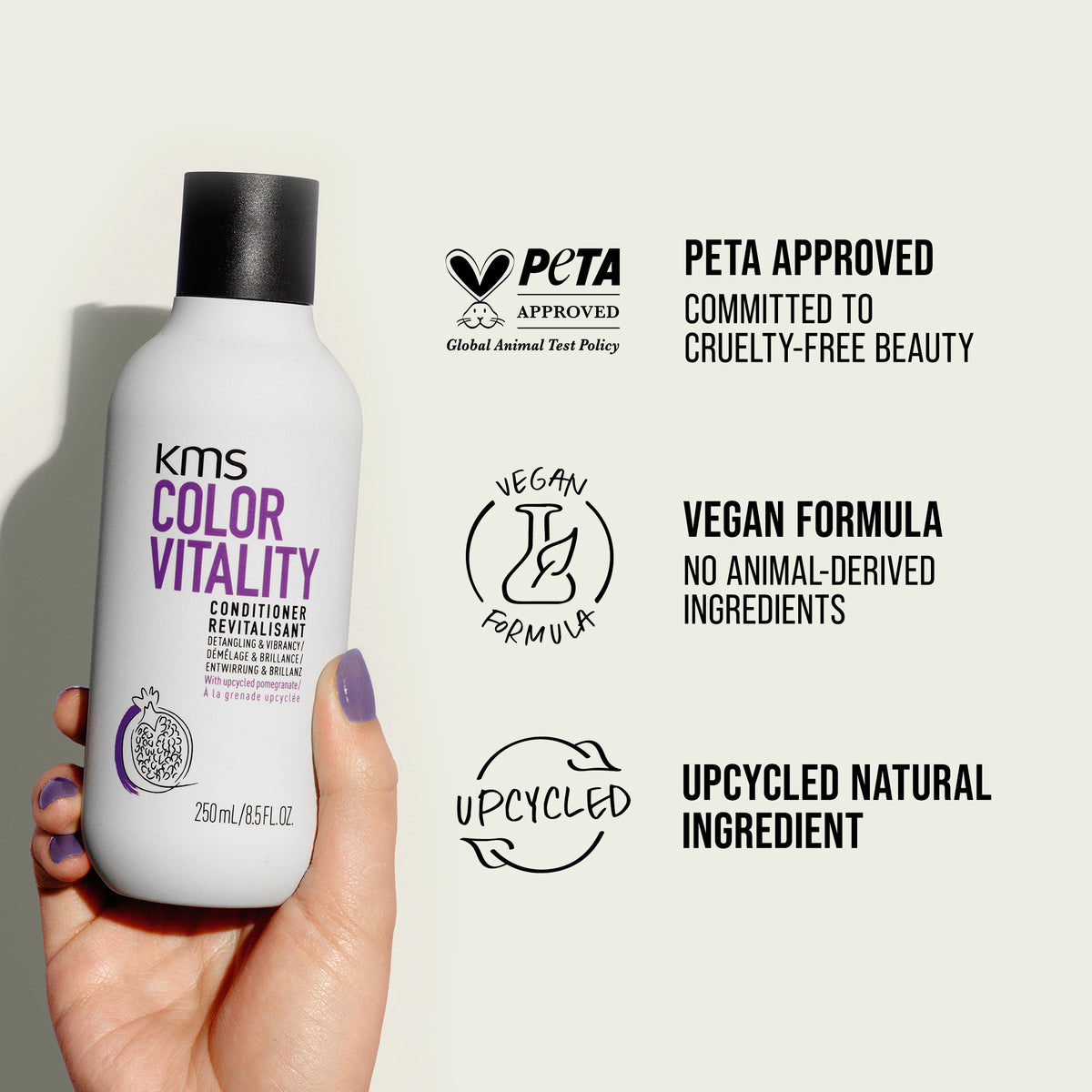KMS Color Vitality conditioner bottle held by a hand with PETA approval and vegan formula labels on a light background.