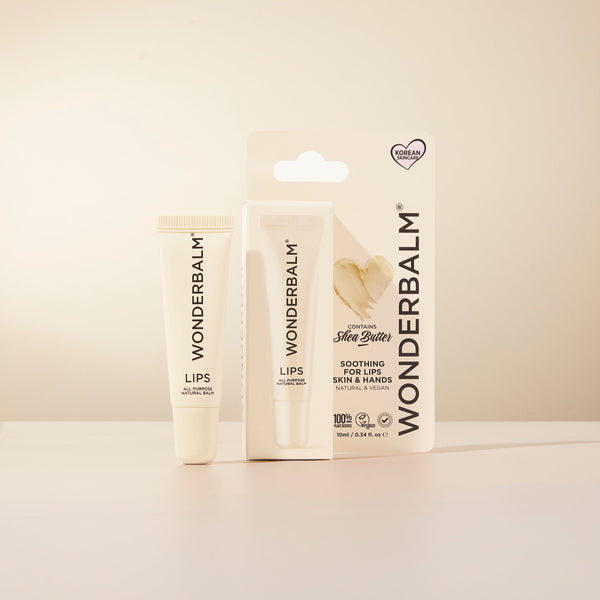 Two Wonderbalm lip balm products on a light beige background