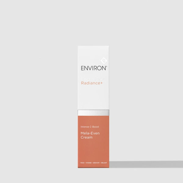 A tall, narrow white and terracotta-colored box for ENVIRON Radiance+ Mela-Even Cream, centered on a light gray background.