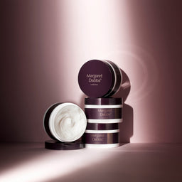 Skincare products with 'Margaret Dabbs' branding on a pink background