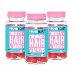 Three clear plastic bottles of Hairburst Chewable Hair Vitamins with bright pink caps and turquoise labels, arranged in a clean studio shot on a white background.