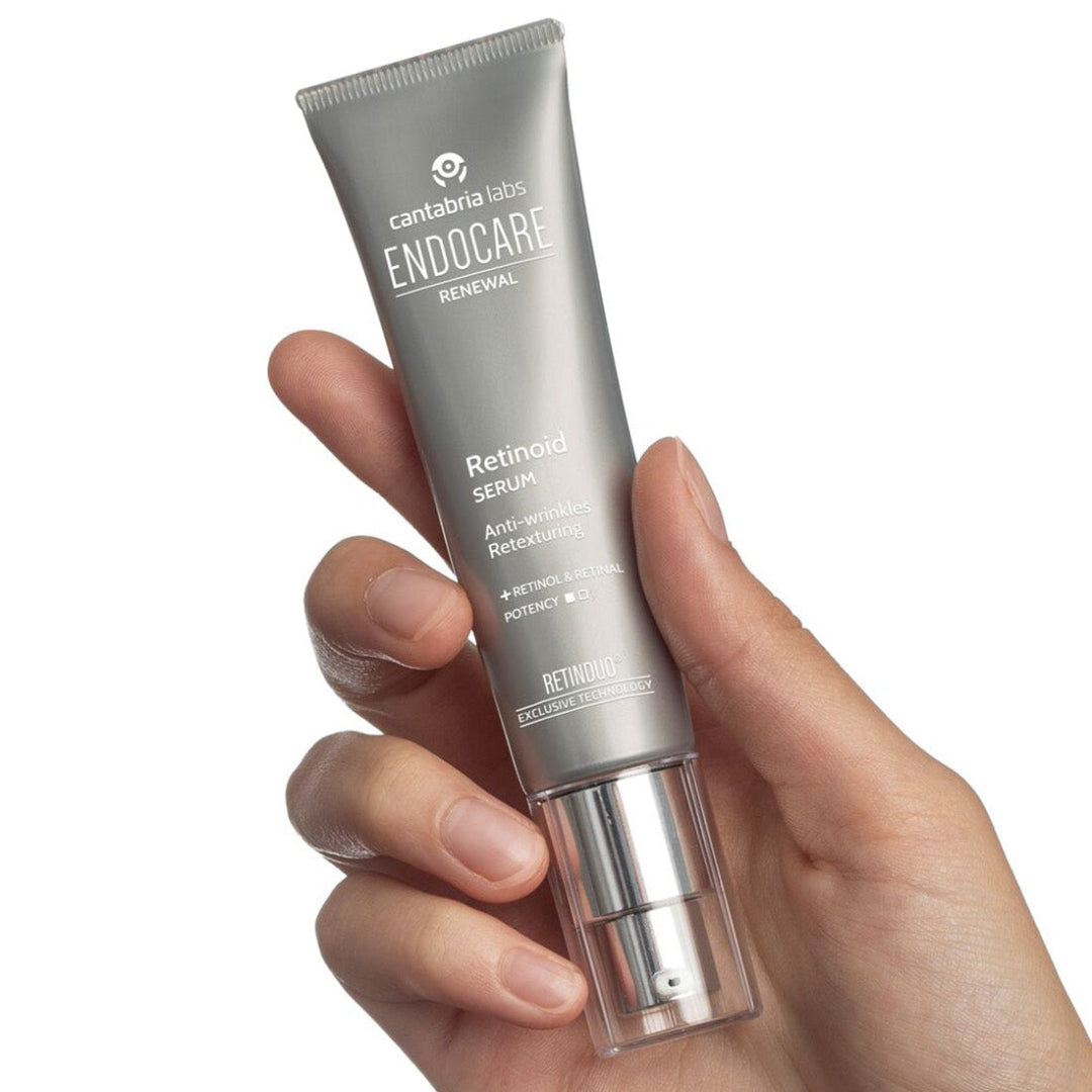 Hand holding a skincare tube labeled 'Endocare' on a white background