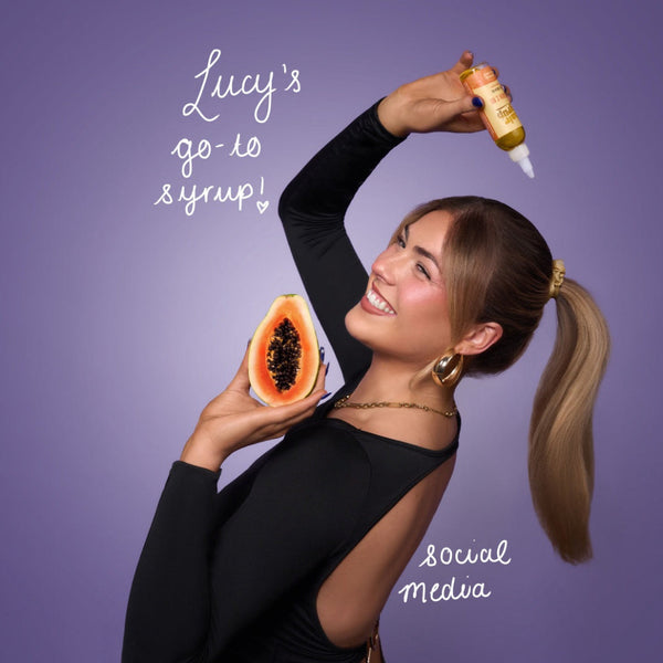 Woman holding a papaya and a bottle with text on a purple background