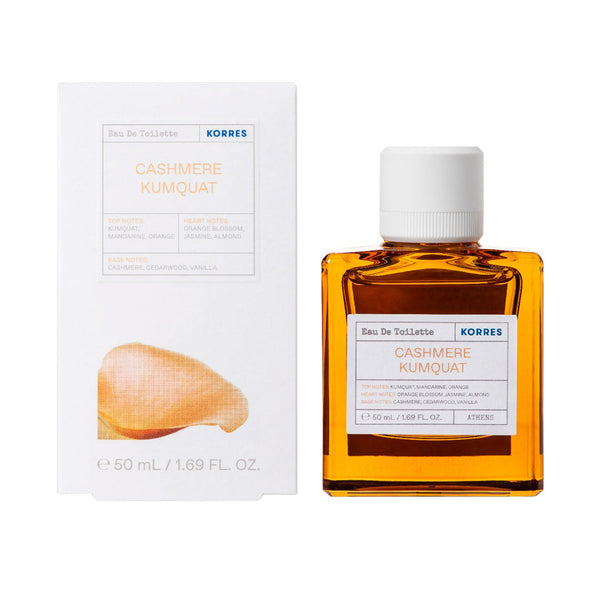 A bottle of KORRES Cashmere Kumquat Eau De Toilette next to its white packaging box, featuring a transparent amber liquid and a white cap.
