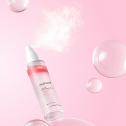 Skincare serum bottle with bubbles on a pink background