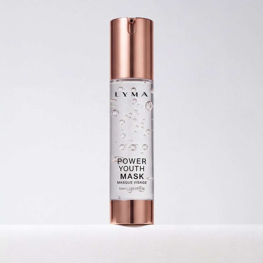 A bottle of Lyma Power Youth Mask (Mascarée Vraie) featuring a clear cylindrical body with visible liquid and bubbles, topped with a metallic rose gold cap and base, set against a clean white background.
