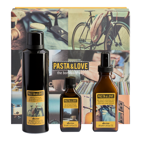 A boxed fragrance gift set from eluvos featuring three dark glass bottles with yellow labels in front of a decorative box. The set includes a tall matte black bottle, a smaller dark amber bottle, and a larger amber spray bottle.