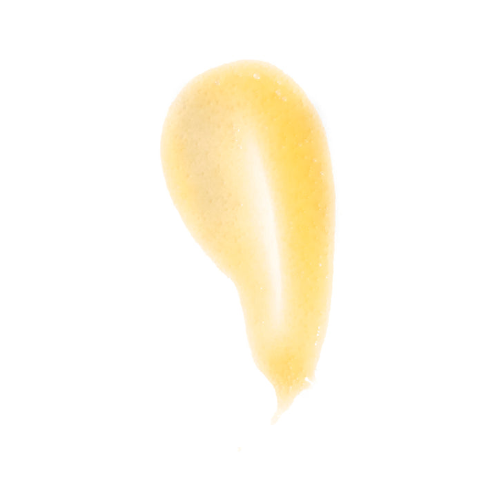 A dollop of pale yellow cosmetic cream or gel on a solid white background.