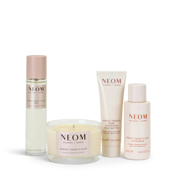 Neom skincare products including a candle, bottles, and a tube on a white background