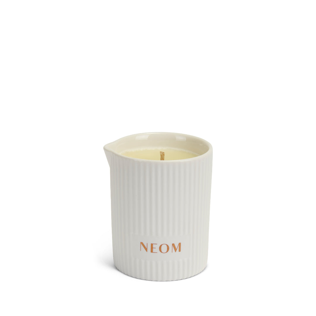 White ribbed candle with 'NEOM' branding on a white background