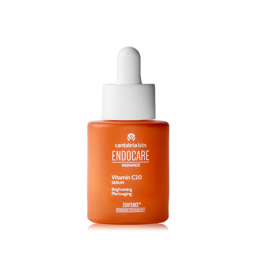 Orange dropper bottle with white cap on a white background