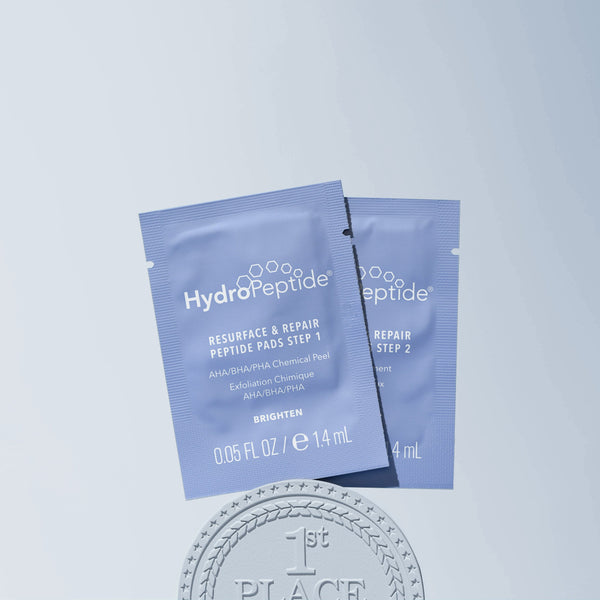 Two HydroPeptide skincare product packets on a light blue background