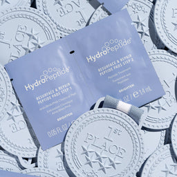 HydroPeptide skincare product packaging on a patterned background