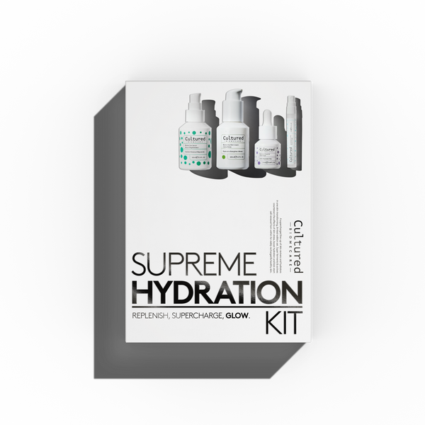 A white product box for the Cultured Botanicals Supreme Hydration Kit, featuring illustrations of skincare bottles on the front, set against a clean white background with a soft drop shadow.