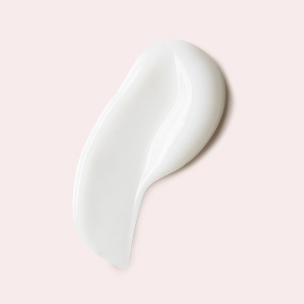 White ceramic spoon on a light pink background