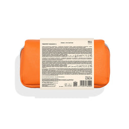 Orange and white cosmetic container with label on a white background