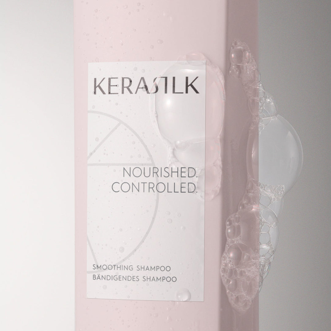 Kerastik shampoo bottle with packaging on a light pink background