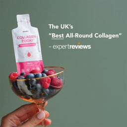 A hand holds a glass filled with berries and a pouch of Zooki Collagen Zook! Berry collagen powder against a muted green background, with promotional text on the right.