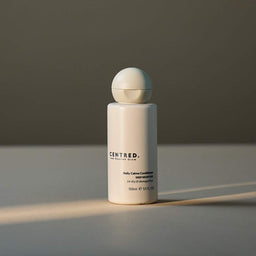 White bottle with spherical cap on a gray surface and background