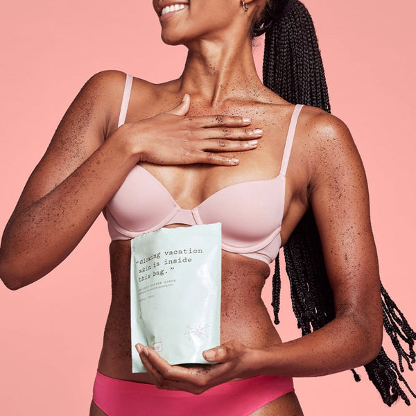Woman holding a book with a pink background