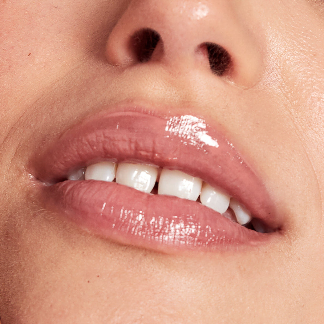 Close-up of a person's lips with a glossy lip product